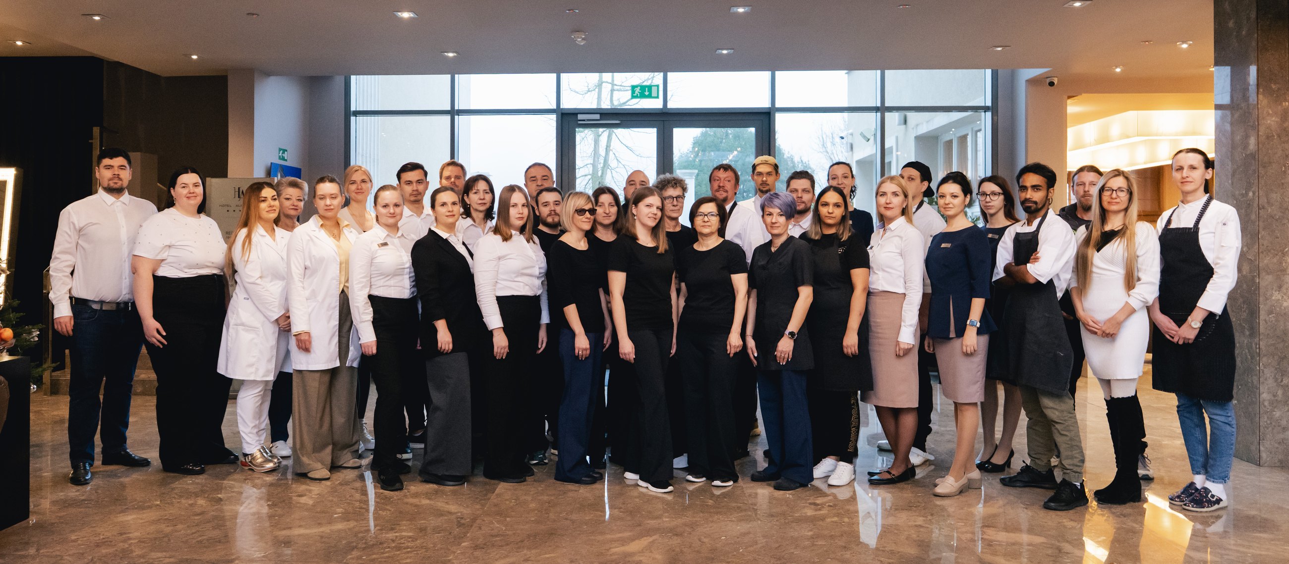 The team of Hotel Aleksander and Revita Clinic in the hotel lobby